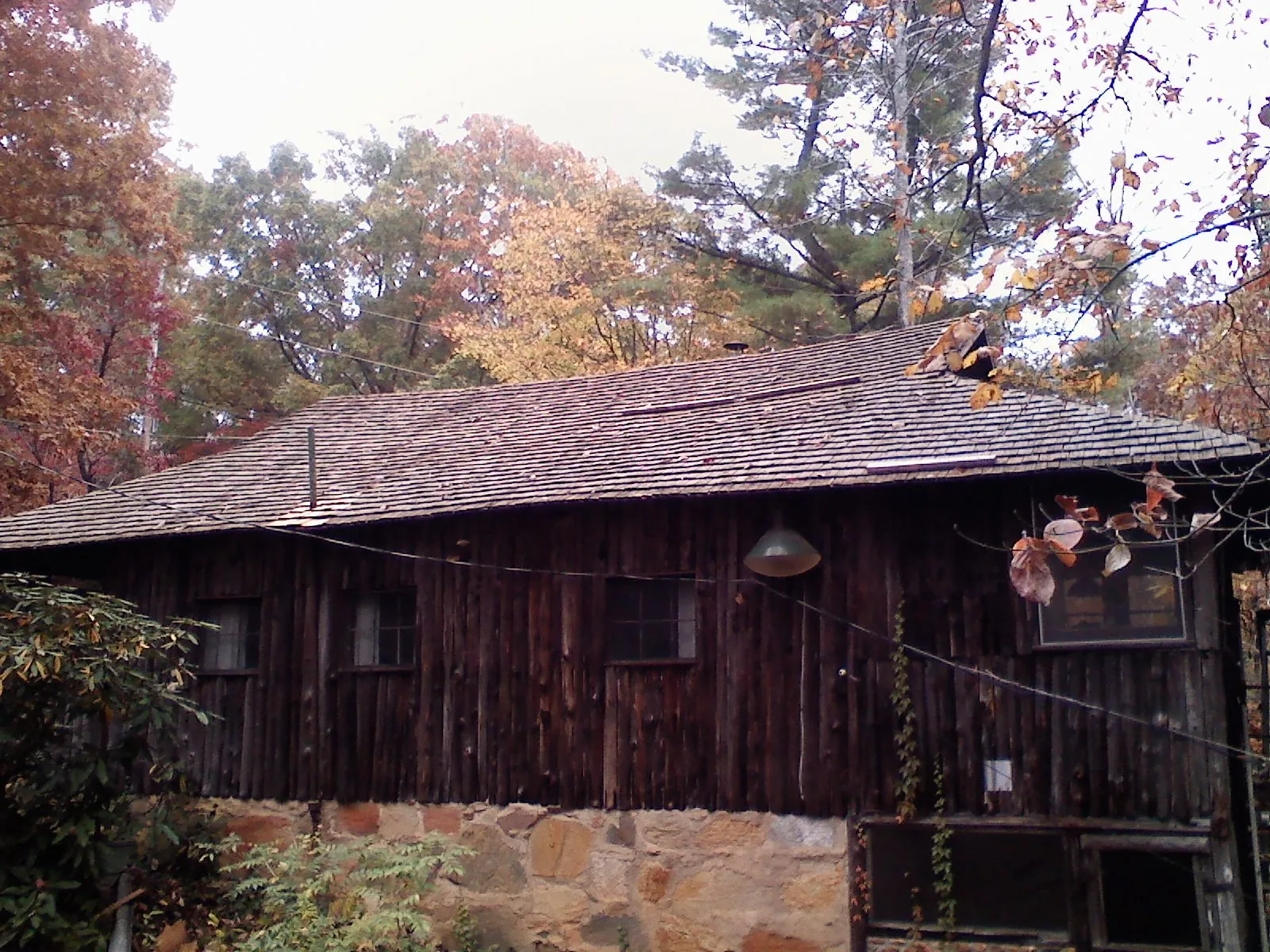 Weathered wood shake roof on a rustic board sided cabin in Loganville